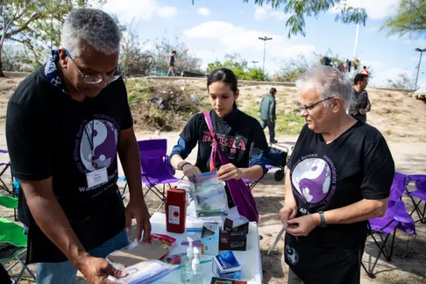 Victor with other people at a vendor booth outside